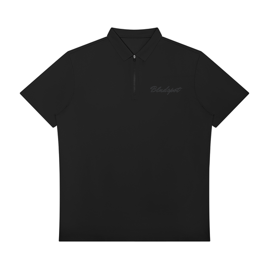 A black short-sleeve polo shirt with a half-zip collar and a subtle dark gray 'Blacklight' script logo on the left chest, displayed against a solid white background.
